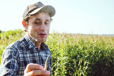 Man smoking marijuana joint on field