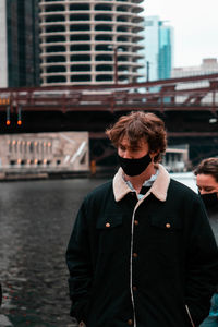 Portrait of young man in city