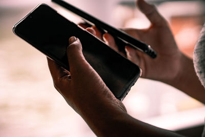 Close-up of hands using phones