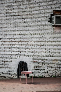 Chair on brick wall