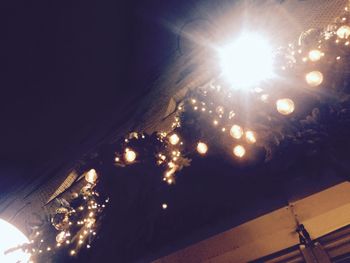 Low angle view of illuminated street light against sky at night