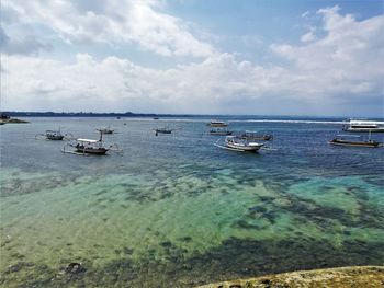 Boats in sea against sky