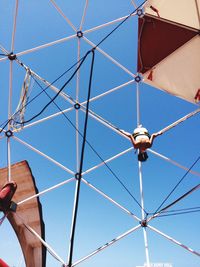 Low angle view of cables against blue sky