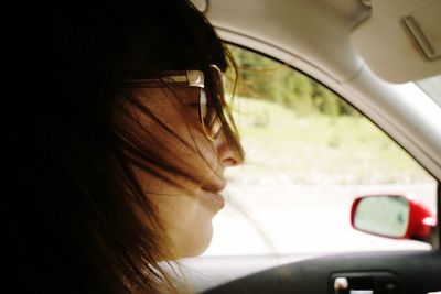 Close-up of woman driving car