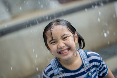 Portrait of smiling girl at fountain in park