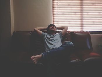 Man sitting on sofa at home