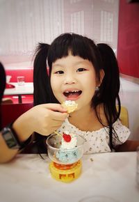 Portrait of girl eating dessert