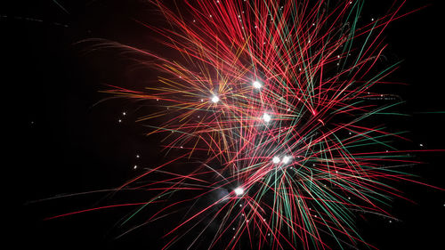 Low angle view of firework display at night