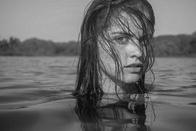 Portrait of woman swimming in lake