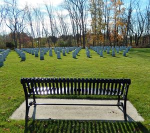 Empty benches in row against the sky