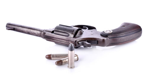 Close-up of revolver over white background