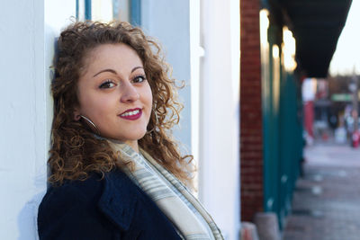 Portrait of smiling young woman standing outdoors