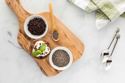 Top down view of a chocolate mousse chia pudding snack with ingredients.