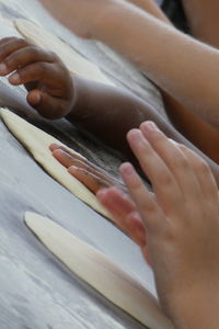 Cropped hands of children preparing food