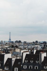 Paris city with eiffel tower against cloudy sky