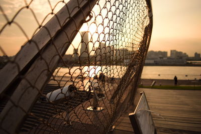 Close-up of umbrella against sky during sunset