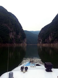 Scenic view of river and mountains against clear sky