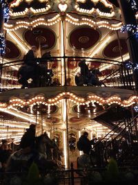 Low angle view of illuminated carousel at night