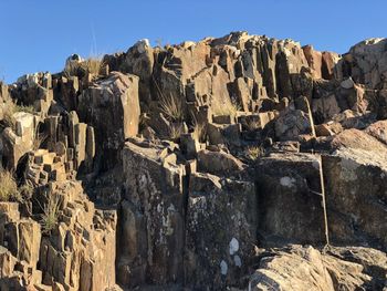 Low angle view of rock formations against sky