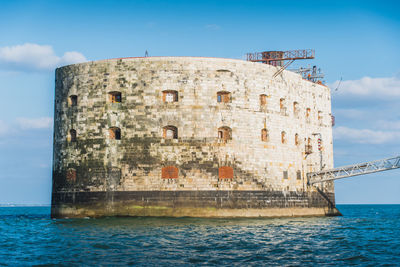 View of historical building against sea