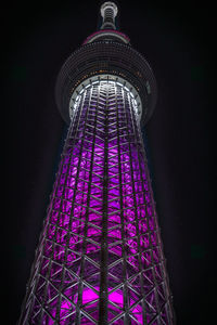 Low angle view of illuminated tower at night