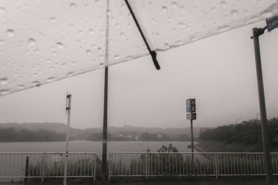 Wet road against sky during rainy season