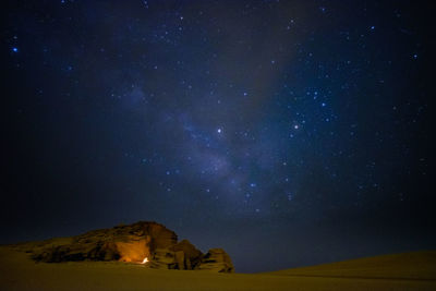 Scenic view of rock formation against sky at night