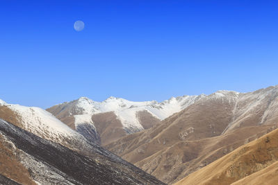 Scenic view of mountains against clear blue sky