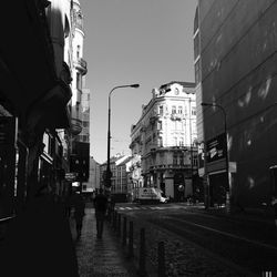 Street amidst buildings against sky in city