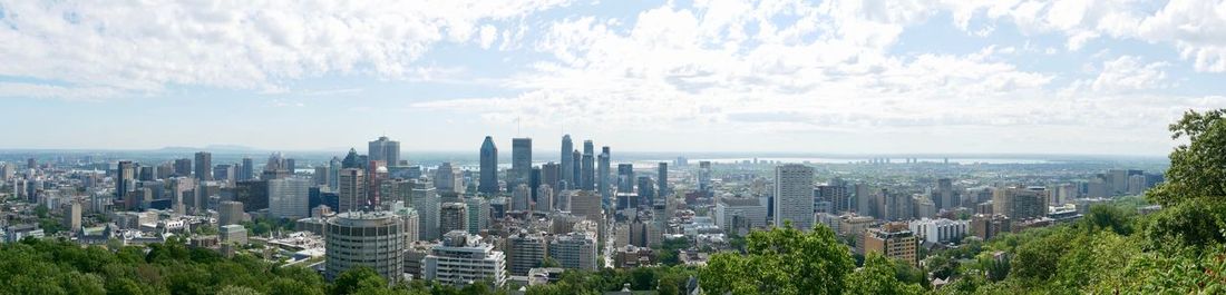 Panoramic shot of city buildings against sky