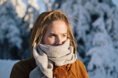 Close-up of beautiful woman looking away during winter