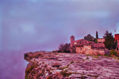 Old building against sky at dusk