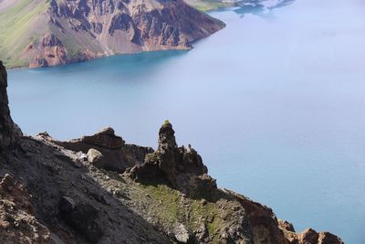 Scenic view of sea and mountains against sky