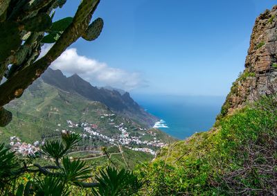 Scenic view of sea and mountains against sky