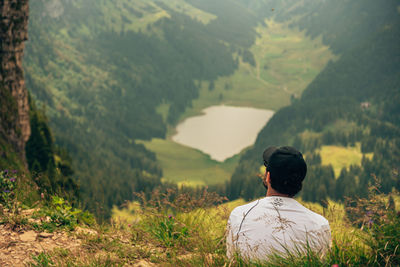 Rear view of man standing on mountain