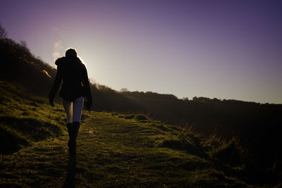 Rear view of woman standing on landscape