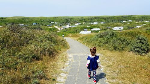 Rear view of women walking on land