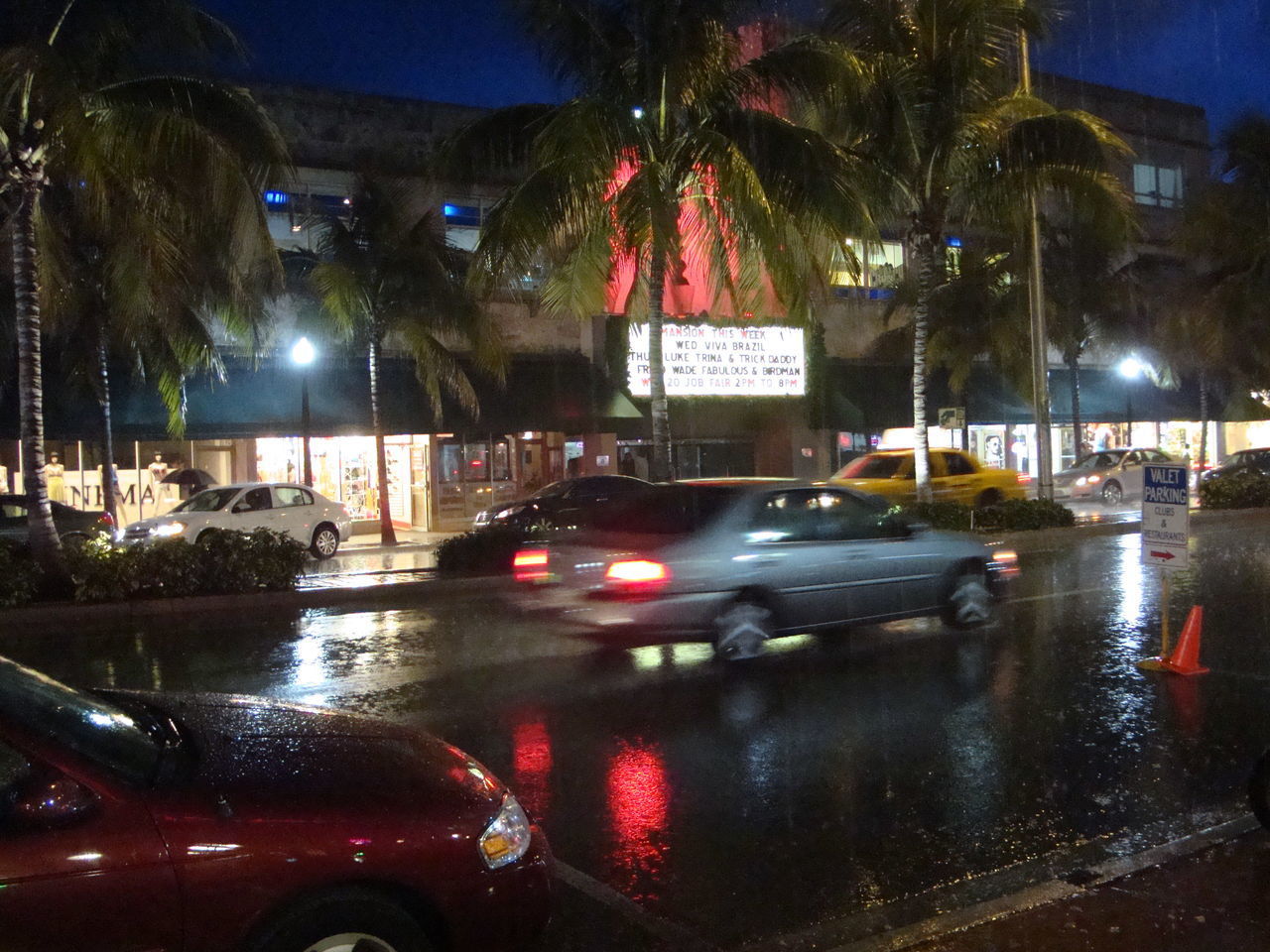 CARS ON WET STREET AT NIGHT