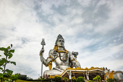 Low angle view of statue against cloudy sky