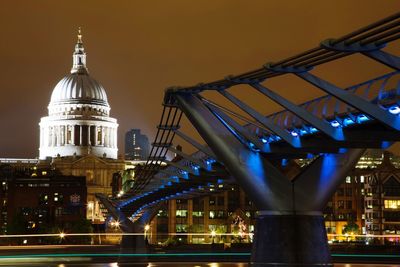 View of illuminated bridge and buildings at night