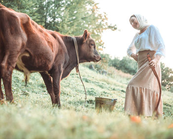 Side view of horse standing on field