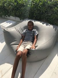 Portrait of smiling boy relaxing on bean bag