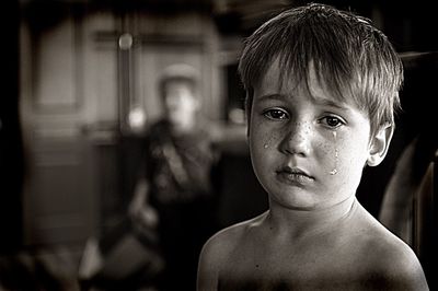 Close-up portrait of shirtless crying boy