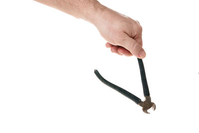 Close-up of hand holding metal against white background