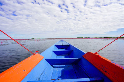 Close-up of boat moored on lake