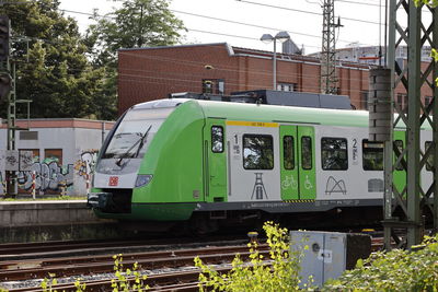 Train on railroad tracks in city