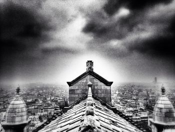 Buildings against cloudy sky