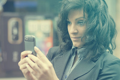 Close-up of young woman using mobile phone