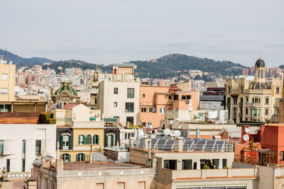 High angle view of houses in city against sky