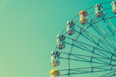 Low angle view of ferris wheel against clear sky